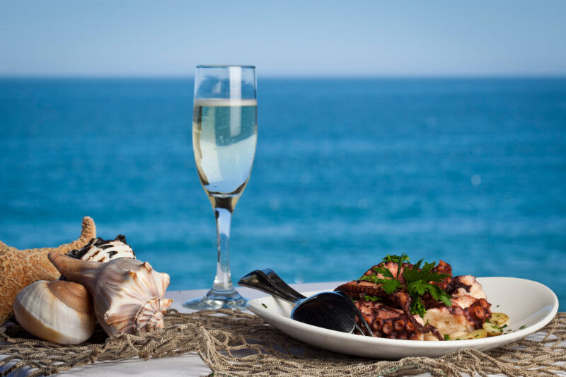 Moonshadows Malibu - Tender Barbecued Octopus, Fingerling Potatoes, Cannellini Beans & glass of champagne