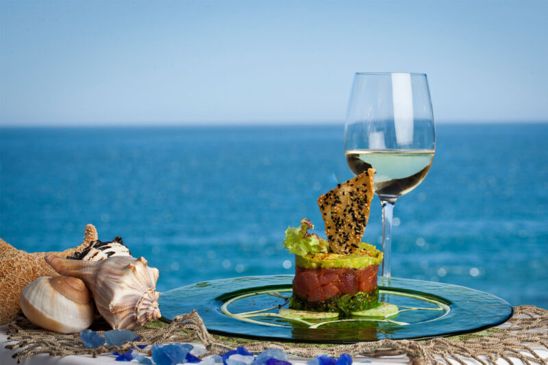 Moonshadows Malibu - Spicy Ahi Tuna Tartare, Cucumber, Seaweed, Wasabi, Avocado, Sesame Wonton Chip & a glass of white wine